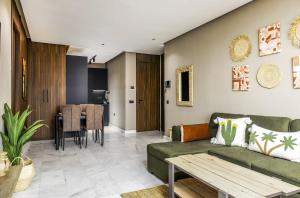 a living room with a green couch and a table at Luxury 1-Bedroom Apartment in Casablanca