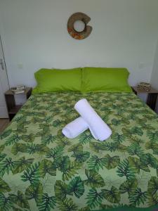 a bed with two rolls of paper towels on it at N'JOK Papeete in Papeete +9 photos