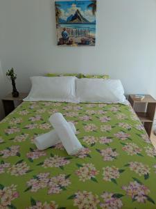 a bed with two rolls of toilet paper on it at N'JOK Papeete in Papeete