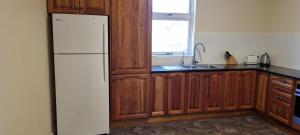 a kitchen with a white refrigerator and a window at River Cottage at Mannum in Mannum