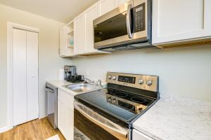a kitchen with a stove and a microwave at 5 Mi to Smithsonian Museum Apt in DC in Washington