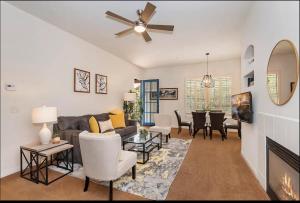 a living room with a couch and a ceiling fan at Luxury 1BR Suite Living Room, Patio, Fp & Kitchen, 12 pools -Legacy Villas in La Quinta