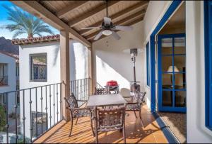 a patio with a table and chairs and a ceiling fan at Luxury 1BR Suite Living Room, Patio, Fp & Kitchen, 12 pools -Legacy Villas in La Quinta