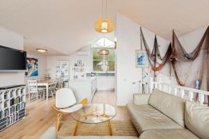a living room with a couch and a table at Osprey 9 in Queenscliff