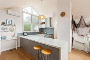 a kitchen with a large counter with stools in it at Osprey 9 in Queenscliff