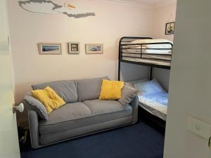 a living room with a couch and a bunk bed at Osprey 9 in Queenscliff