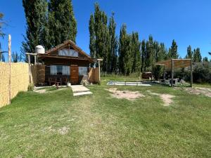a small house in a field with a yard at Cabanas Embau in San Rafael +4 photos