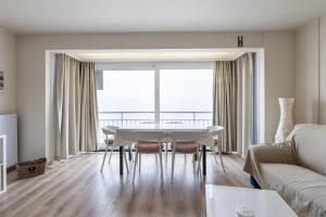 a living room with a table and a couch at Horizon 0501 P in Sint-Idesbald