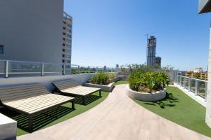 two benches on the roof of a building at Ventura Carmelitas in Asuncion