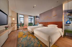 TV a/nebo společenská místnost v ubytování Manju Hotel Zhuzhou Tianyuan District Midea City Times Square
