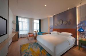 Postel nebo postele na pokoji v ubytování Manju Hotel Zhuzhou Tianyuan District Midea City Times Square