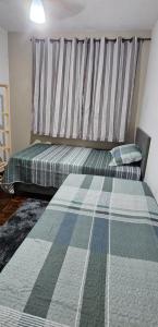 a bedroom with a bed with a striped headboard at Apartamento para temporada 2 quartos coqueiral de itaparica in Vila Velha