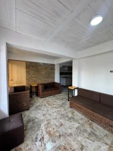 an empty room with couches and tables in a building at El guadual apartahotel in Salento