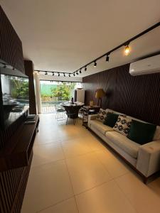 a living room with a couch and a table at Casa em condomínio fechado in Barreirinhas