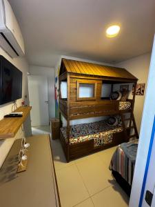 a small room with a bunk bed and a desk at Casa em condomínio fechado in Barreirinhas +8 photos