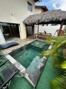 a swimming pool in front of a villa at Casa em condomínio fechado in Barreirinhas