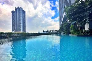 a large pool of blue water between two tall buildings at Trion KL, Jalan Chan Sow Lin, Kuala Lumpur by One Guesthouse in Kuala Lumpur