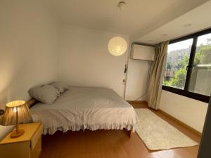 a bedroom with a bed and a lamp and a window at 2 bedroom near the Egyptian museum in Cairo