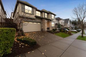 a house with a driveway with a garage at Spacious family and kids friendly house with backyard, fireplace, grill perfect for work crews in Beaverton