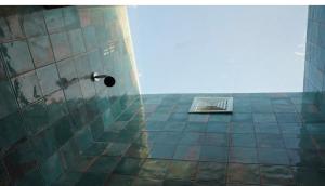 a bathroom with a shower in the corner of a building at Casa cayito l in Arecibo +13 photos