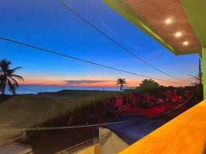 a view of a sunset from a balcony at Casa cayito l in Arecibo