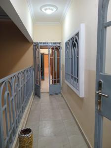 a hallway with a door and a hallway with a basket at Appartements PALOU in Motsouémbé