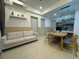 a living room with a couch and a table at Trion KL, Jalan Chan Sow Lin, Kuala Lumpur by One Guesthouse in Kuala Lumpur