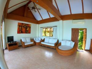 a living room with white furniture and a ceiling at MJ Beautiful sunset beach house in Ban Na We