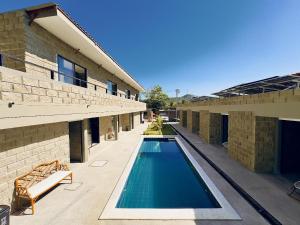 a swimming pool in front of a building at Villa pio blue in Santa Verónica