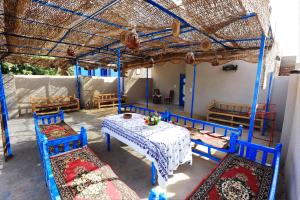 a dining room with blue chairs and a table at Dreams By Mon in Al Karnak