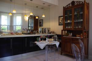 a kitchen with a table with chairs and a counter top at La Piccola Locanda in Modica