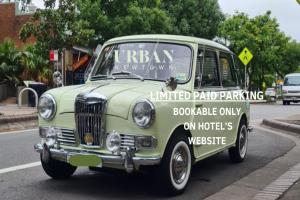 an old green van is parked on a street at The Urban Newtown in Sydney