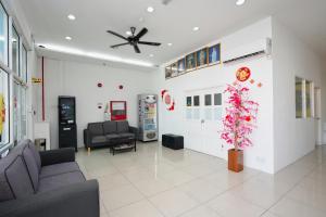 a waiting room with two couches and a plant at Grand Inn Hotel - Macalister Road in George Town