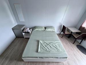 a small room with two beds and a desk at A Residences in San Fernando