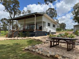 a house with a picnic table in front of it at Wallawa on Hilltop in Ellesmere