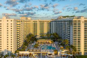 an aerial view of a large building with a pool at Ultra Luxe Direct Ocean Penthouse at 1 Hotel in Miami Beach