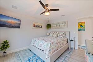 a bedroom with a bed and a ceiling fan at Magical Waterfront Cove with Pool, Dock, Boat Slip & Magic Garden in Largo +28 photos