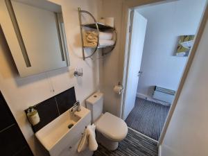 a small bathroom with a toilet and a sink at Miricia Guest House in Scarborough +31 photos