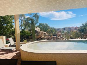 a large swimming pool with a view of a city at Casita Christie in El Pueblito