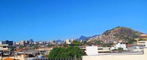a view of a city with buildings and mountains at Pousada Andrey in Niterói