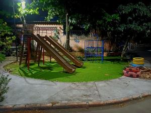 a playground with a slide in a park at Pousada Andrey in Niterói