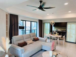 a living room with a couch and a ceiling fan at The Atrium at Jalan Ampang by OKBnB - Luxury 3 Bedroom Family Suite with Balcony, 3 mins to KLCC in Kuala Lumpur