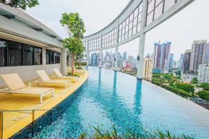 a hotel swimming pool with a view of a city at The Atrium at Jalan Ampang by OKBnB - Luxury 3 Bedroom Family Suite with Balcony, 3 mins to KLCC in Kuala Lumpur