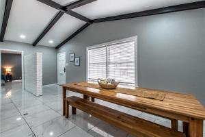 a dining room with a wooden table and a window at Contemporary Coastal Oasis Awaits in Corpus Christi +54 photos