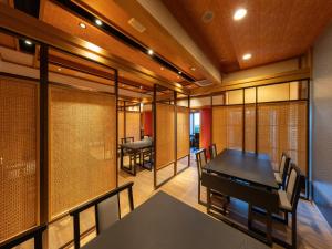 a dining room with a table and chairs at Kaiyutei in Kawazu