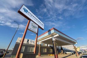 a street sign in front of a gas station at Sternwheeler Hotel & Conference Centre, Trademark by Wyndham in Whitehorse