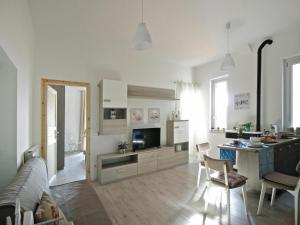 a living room with a couch and a table and a kitchen at Apartment in Ladispoli near Tyrrhenian Sea in Ladispoli