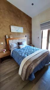 a bedroom with a large bed with a blue comforter at Loft Foresta in Santeagueda +34 photos