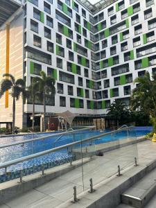 a large building with a swimming pool in front of a building at Republic Plaza Airpot Tân Sơn Nhất view sân bay in Ho Chi Minh City +23 photos