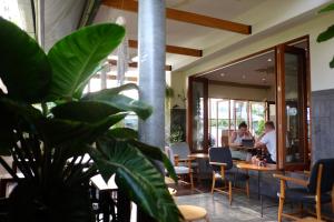 two people sitting at a table in a restaurant at Just Fine Krabi in Krabi